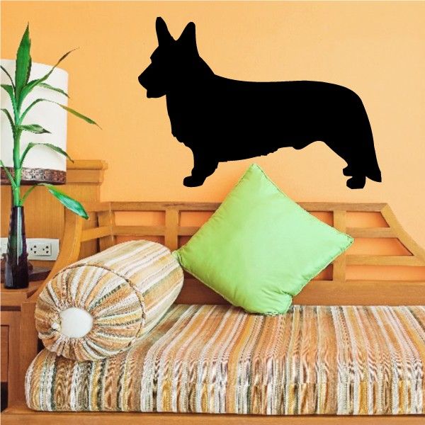 Standing Welsh corgi decal, black silhouette on a wall above a sofa