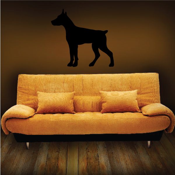 Standing Doberman Pinscher decal with black silhouette on light sofa back