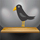 Staring Crow sticker of a black bird with yellow beak and legs