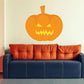 Jack-o-lantern sticker with orange pumpkin face and jagged grin, creepy eyes