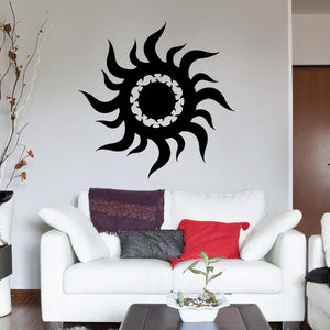 Tribal sun wall decal with black swirl rays and circular center on wall