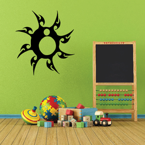 Tribal sun wall decal with bold black rays and green center circle