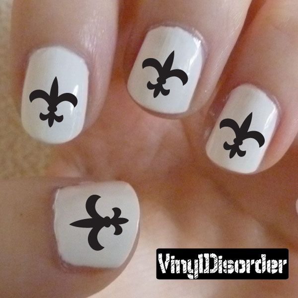 Fleur-de-lis nail art stickers on short white nails with black symbols, set of decals