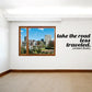 Wall decal with city window scene and quote text: take the road less traveled.
