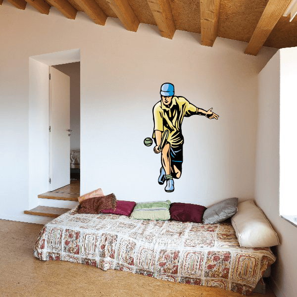 Tennis wall decal of cartoon player holding racket, yellow shirt, blue hat and shoes.