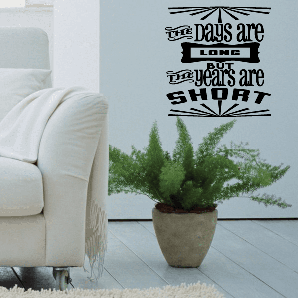 Black typographic wall decal: 'The Days are Long but the years are short'.