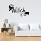 Black wall decal reading 'The Witch is in' with witch hat icon