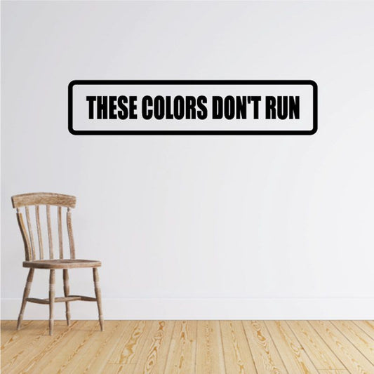 Wall decal with black outline and bold text "THESE COLORS DON'T RUN"