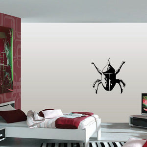 Black beetle wall decal with horn-like upward antenna detail