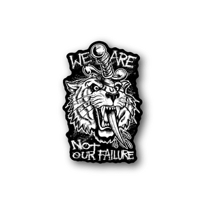 Vinyl sticker: roaring tiger, dagger, and text 'WE ARE' / 'NOT OUR FAILURE'.