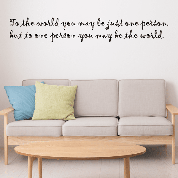 Wall decal with cursive quote text: “To the world...one person...the world”