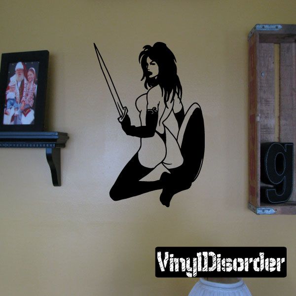 Warrior woman looking-back wall decal with bare chest and raised sword