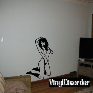Pinup wall decal of a kneeling woman in black line art, hand on head pose