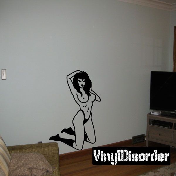 Pinup wall decal of a kneeling woman in black line art, hand on head pose