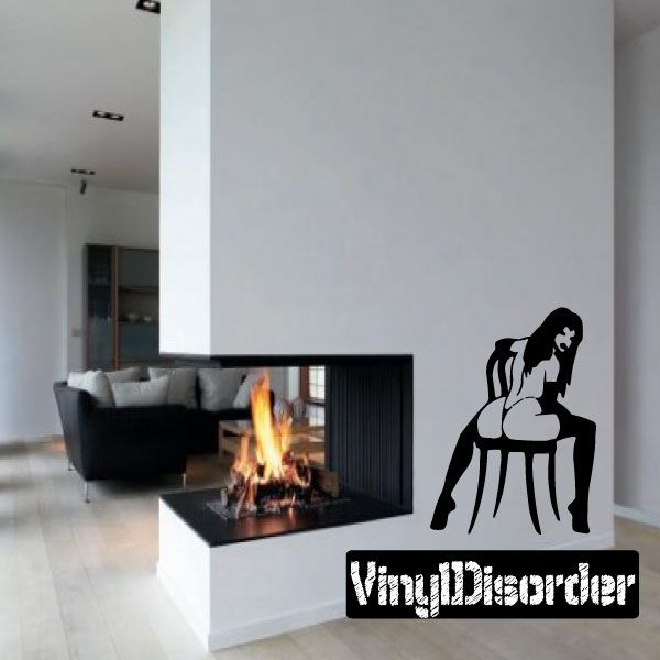 Black silhouette wall decal of topless woman sitting backwards in chair.