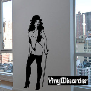 Black decal of a woman in vest with cane, silhouette style