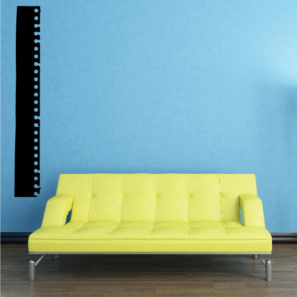 Torn film strip wall decal with black strip and vertical perforation holes
