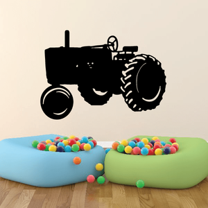Black tractor decal silhouette for walls, featuring detailed wheel and cab outline