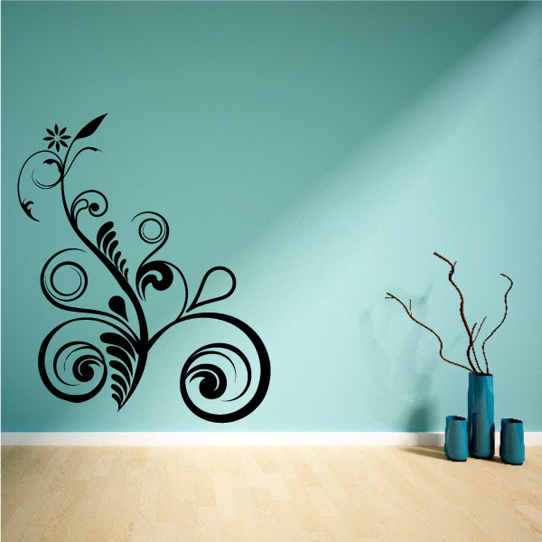 Tree branch wall decal with curling vines and leaf swirls in dark ink