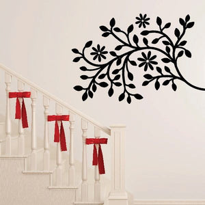Tree branch wall decal with black floral blossoms and leaves