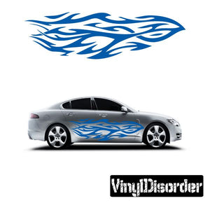 Tribal flame vinyl decal in blue and white, applied along car side panel.