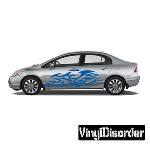 Vinyl flame car decal with blue tribal swirl flames, applied on a light gray sedan