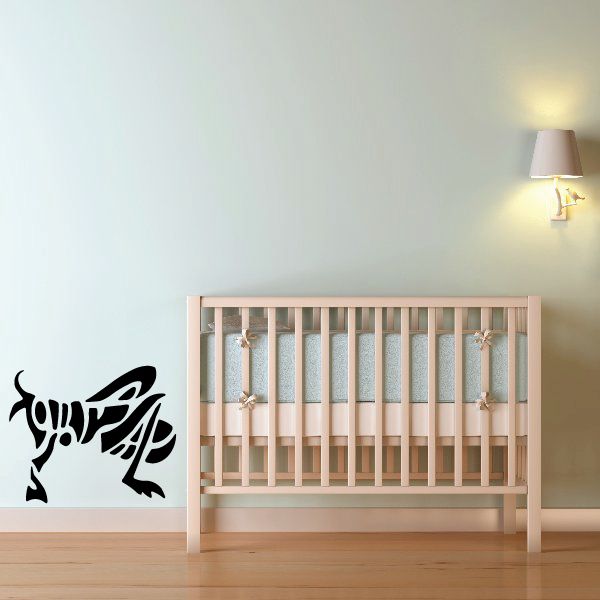 Tribal grasshopper wall decal, black stylized insect design.