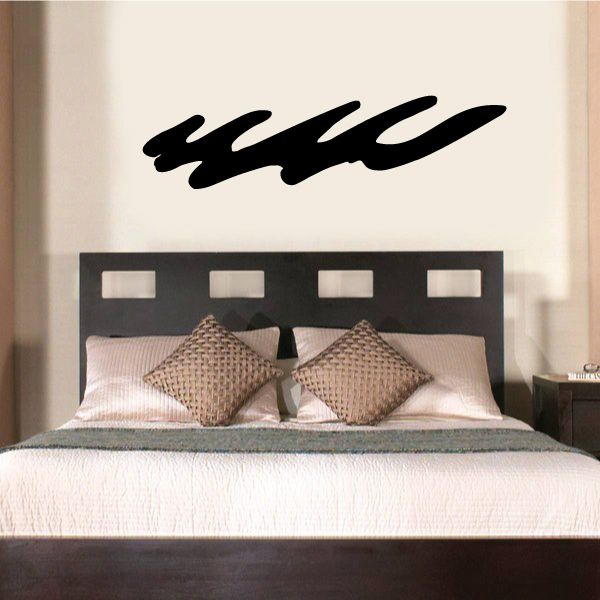 Tribal wall decal with black swooping script on a light wall