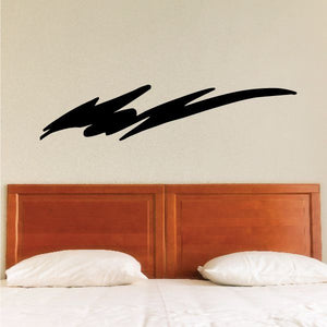 Tribal pinstripe wall decal, black swoosh-style design above a bed