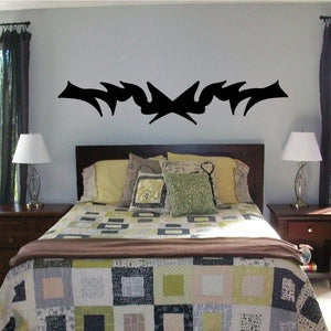 Tribal pinstripe wall decal, black vinyl sticker with a spiky bat-like shape