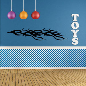 Blue wall decal with black tribal flame and vertical TOYS letters, polka-dot band