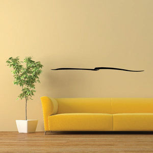 Black vinyl wall decal with a curved stripe and small center dot
