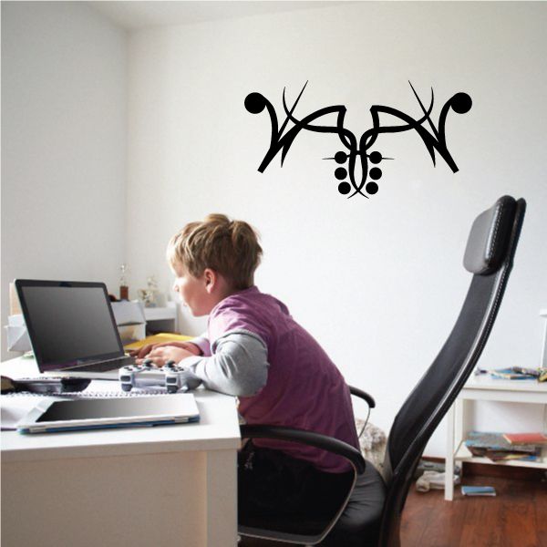 Black tribal pinstripe wall decal with central emblem and curved antler-like shapes