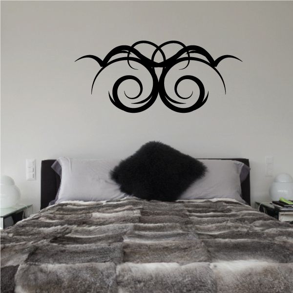 Tribal pinstripe wall decal with two black swirled eye shapes and curved lines