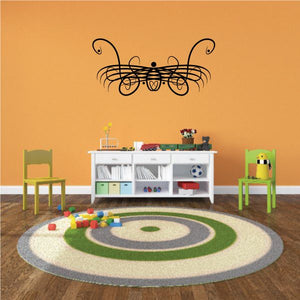 Tribal wall decal featuring a black scrollwork design with central dots