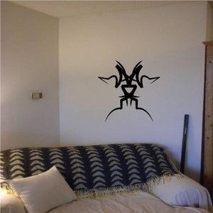 Tribal wall decal featuring a black spiky cat-like silhouette with long whiskers
