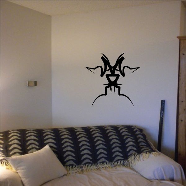Tribal wall decal featuring a black spiky cat-like silhouette with long whiskers