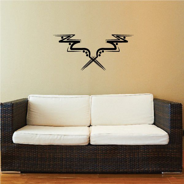 Tribal wall decal with black swirling design and arrows on a light wall