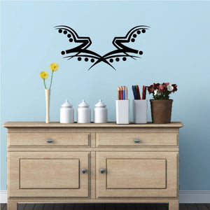 Black tribal bird wall decal with dotted wings and curved tail accents