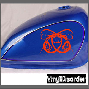 Vinyl tribal decal with red line-art design on a blue car panel
