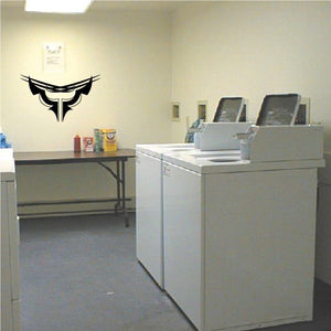 Tribal pinstripe wall decal with black outlined emblem on a light wall