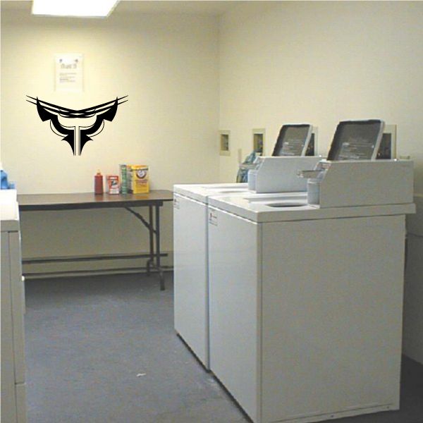 Tribal pinstripe wall decal with black outlined emblem on a light wall