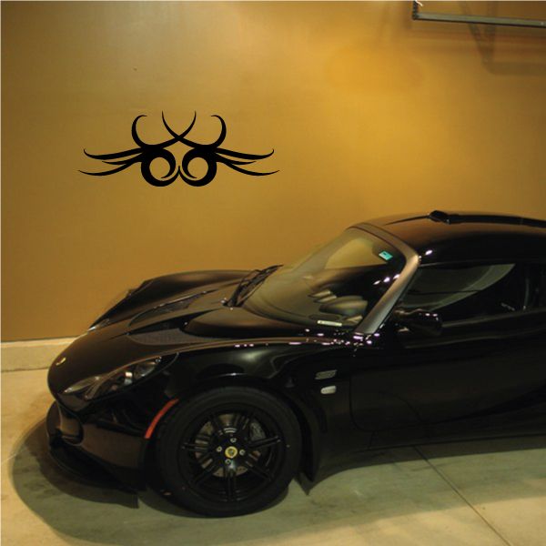 Tribal wall decal featuring a black pinstripe emblem with swirling lines