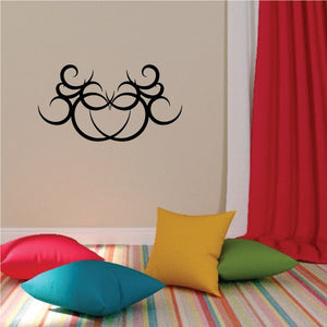 Tribal wall decal with black ornate swirl design on a beige wall