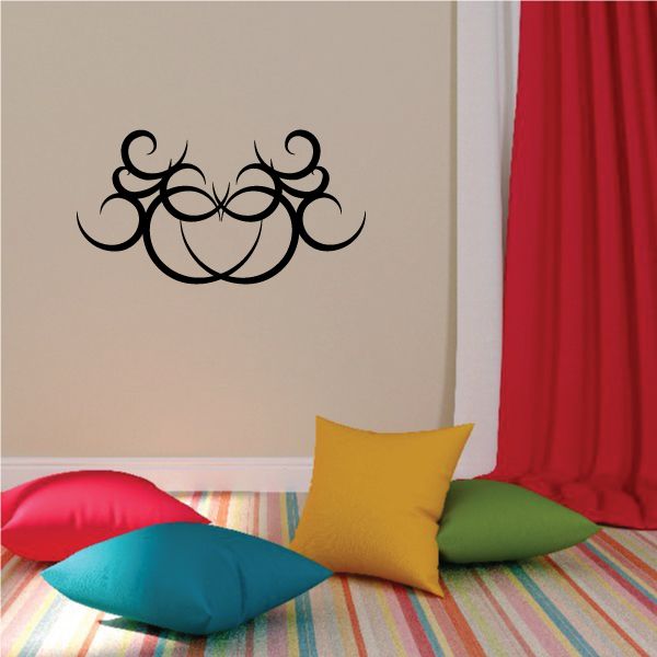 Tribal wall decal with black ornate swirl design on a beige wall