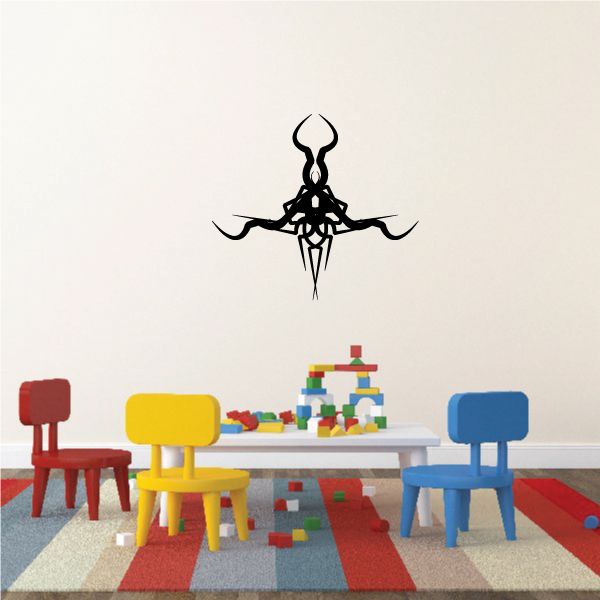 Tribal wall decal with black stylized emblem and pointed center