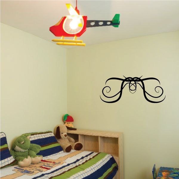 Tribal-style wall decal with black ornate curly mustache design