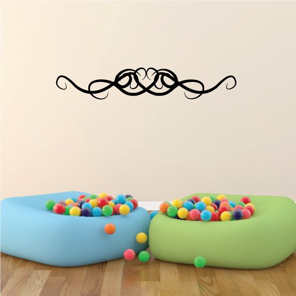 Black tribal swirl vinyl wall decal with scrollwork and central emblem.