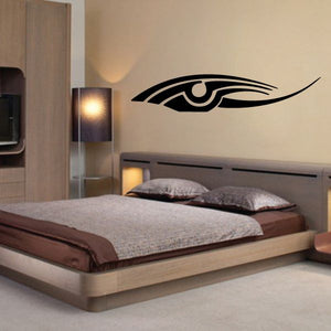 Tribal vehicle pinstripe vinyl decal with black eye-like symbol on wall