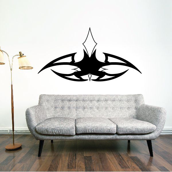 Black tribal vehicle pinstripe wall decal vinyl, centered emblem above sofa.